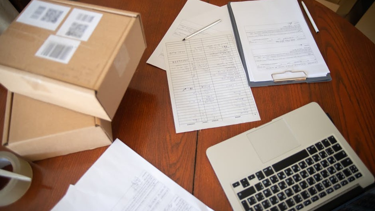 Stack of paperwork and faxes representing complex logistics of direct car shipping