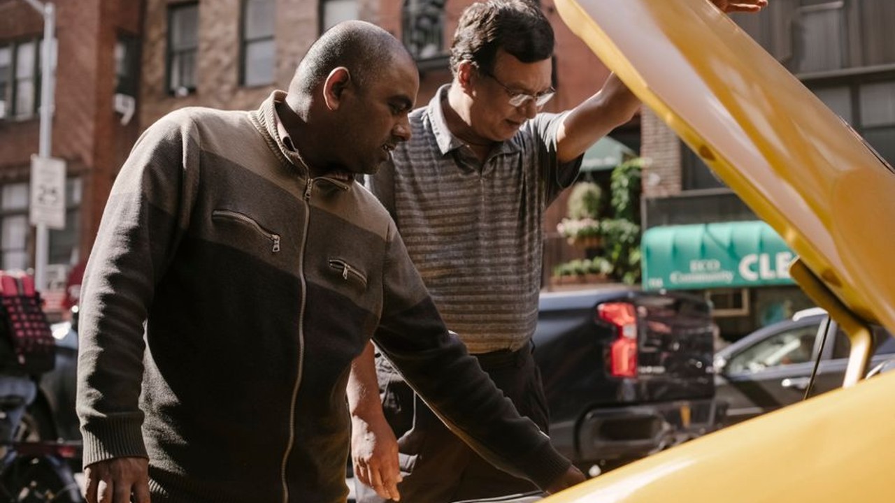 Driver inspecting a vehicle for pre-existing damage before loading onto a car hauler