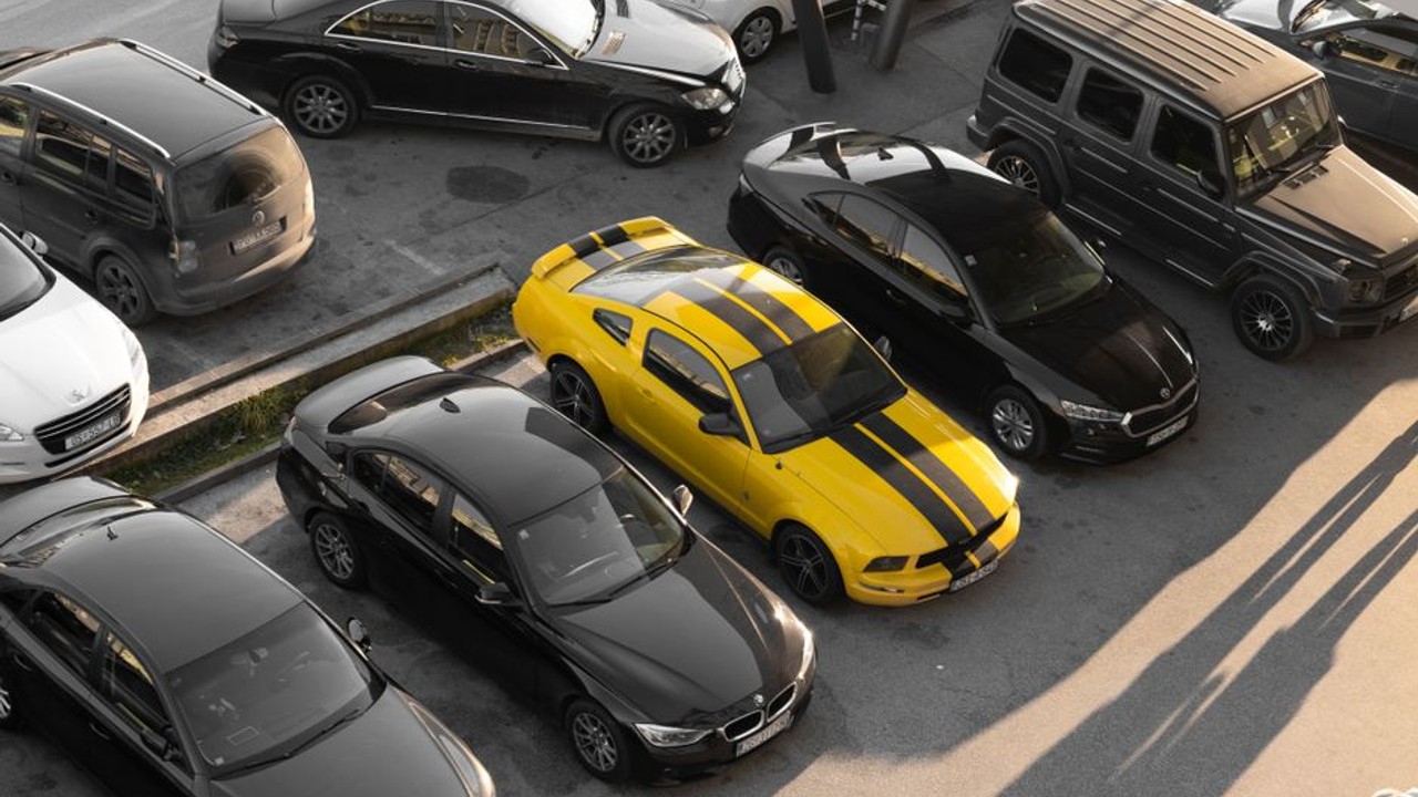 Top-down view of a car carrier truck with several sedans and SUVs meticulously arranged, ready for a cross-country journey, showcasing efficient use of space